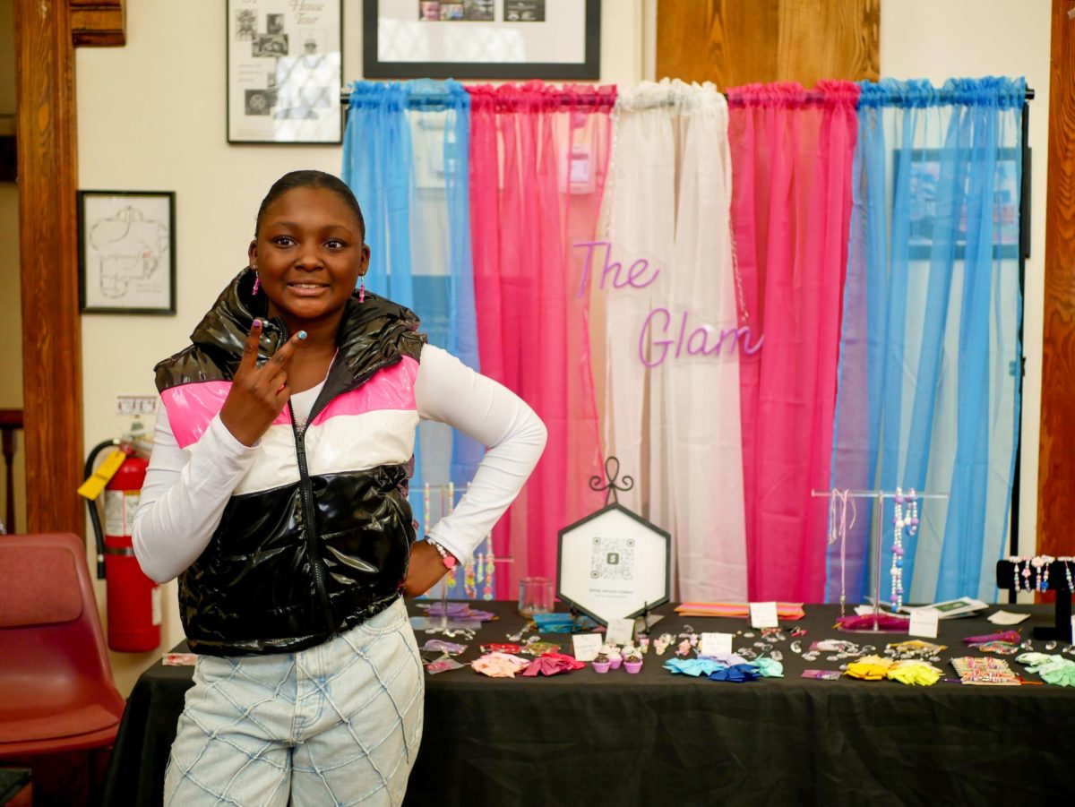 Johnson-Cedeno poses for a picture in front of her jewelry shop, The Glam. She was the youngest vendor at the Market at 11 years old.