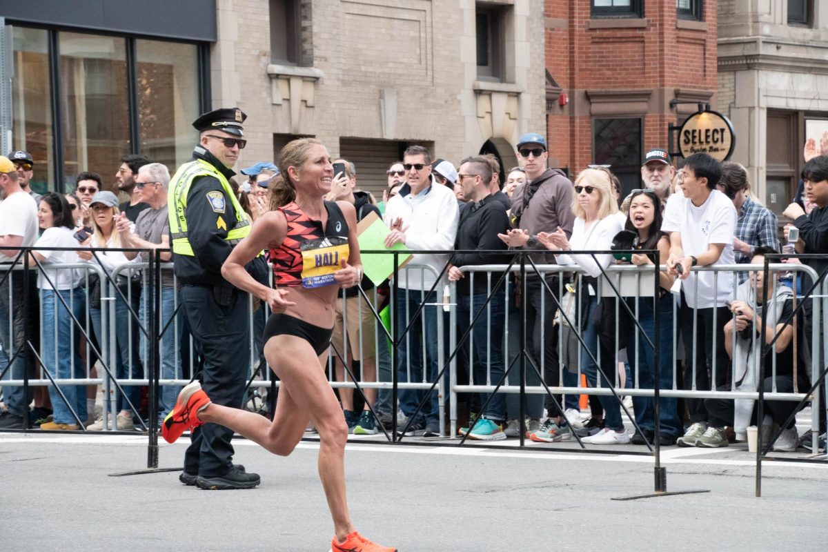 Sara Hall runs in the Boston Marathon as spectators watch. Hall finished 15th in the Marathon on her 41st birthday while raising funds for women in Ethiopia.