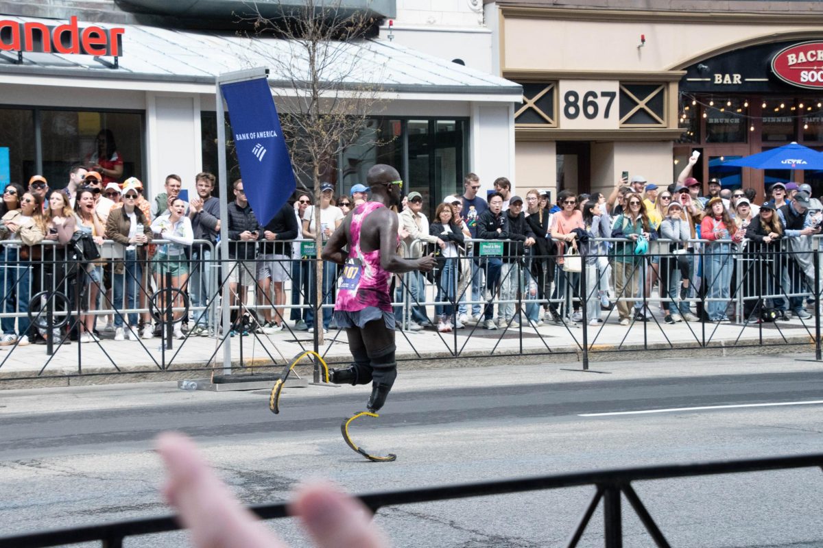 Double amputee runner Marko Cheseto Lemtukei runs down Boylston Street. He completed the marathon with a 2:46:45 finish time. 