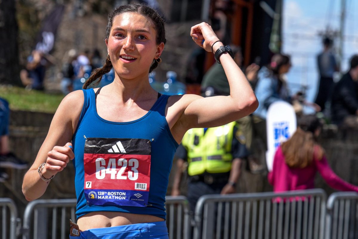 Lee Milne raises her fist as she runs the Boston Marathon April 15. Read more here.