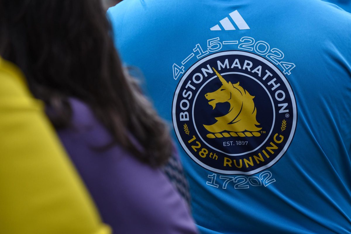 Danielle Fenner, a supporter of a marathon runner, sports a 2024 Boston Marathon shirt. Many spectators wore blue and yellow to support marathon participants.