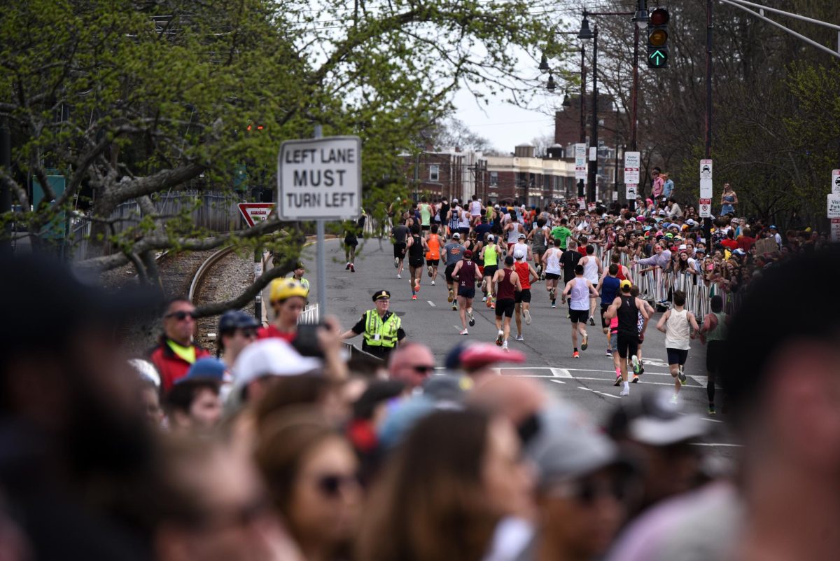 Runners make their way up Commonwealth Avenue at mile 21 as they advance to the last several miles of the marathon. Boston College sponsored food vendors, yoga classes and a student-only concert featuring singer and rapper T-Pain for Marathon Monday. 