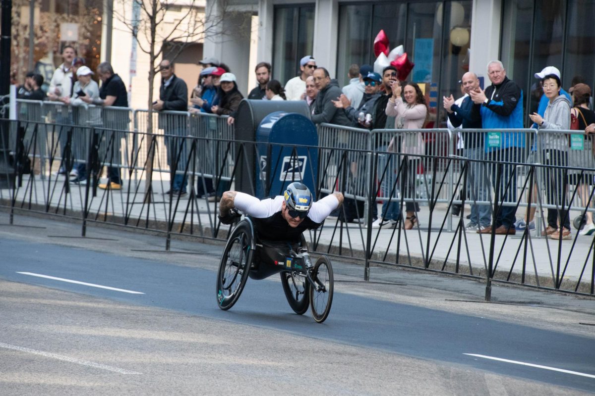 David Weir makes his way down Boylston Street as spectators clap.Various para athletics divisions made the marathon accessible for more competitors.