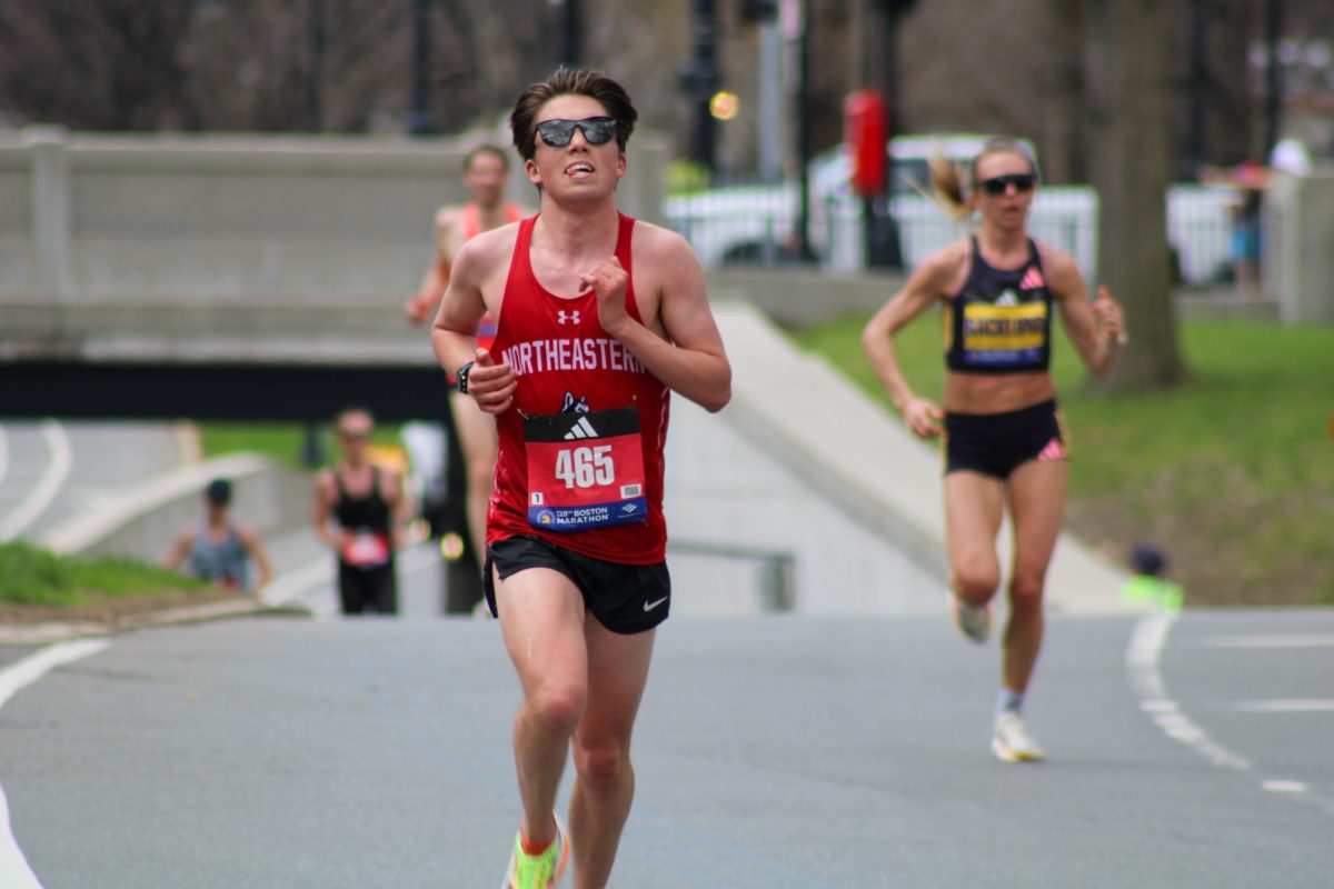 Nicolas Ferretti, a Northeastern fourth-year mechanical engineering major, runs in the final mile of the marathon. Many college athletes participated in the marathon.
