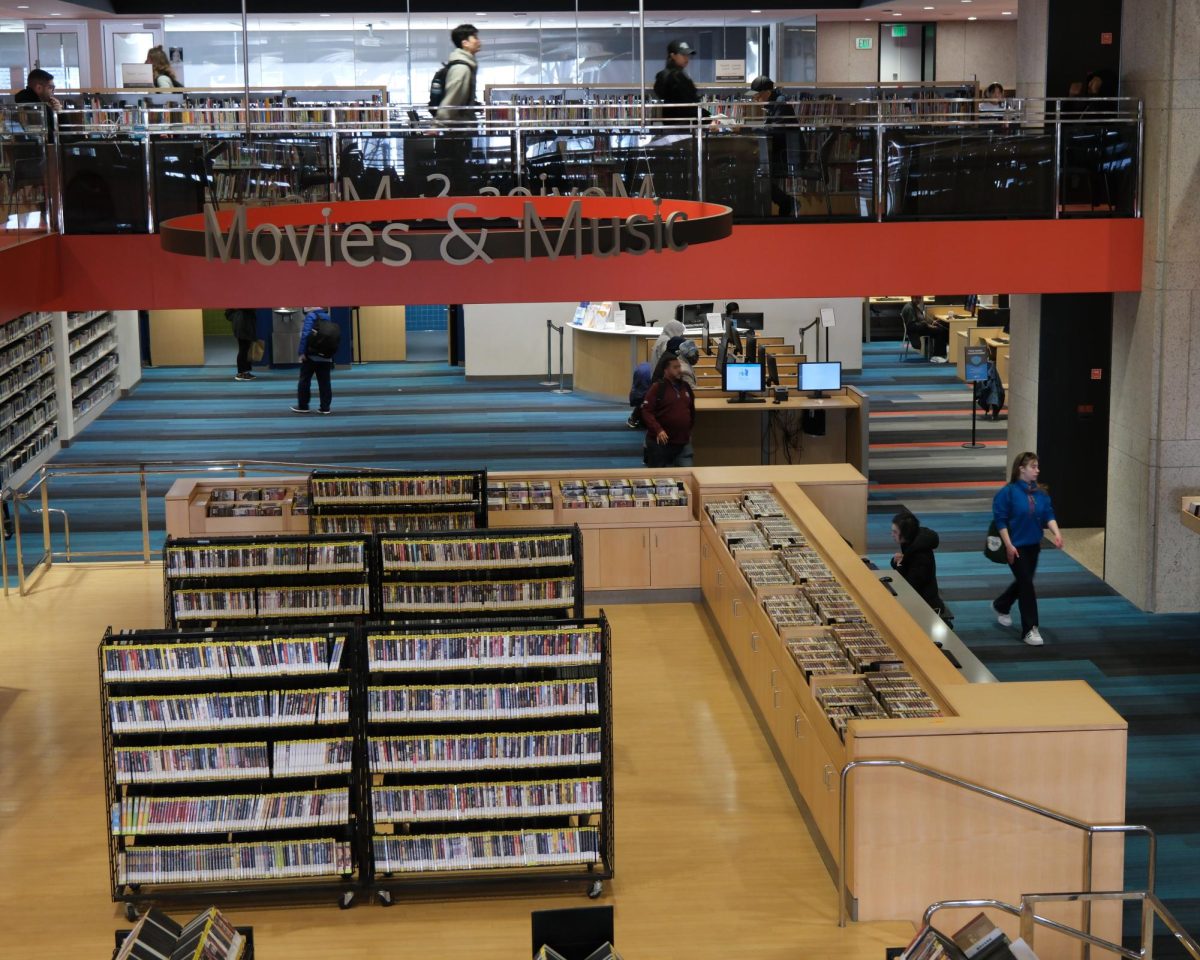 A “Movies & Music” display hangs in the BPL Central Library. DVDs and CDs were once only available in physical copies, but are now accessible via streaming online.