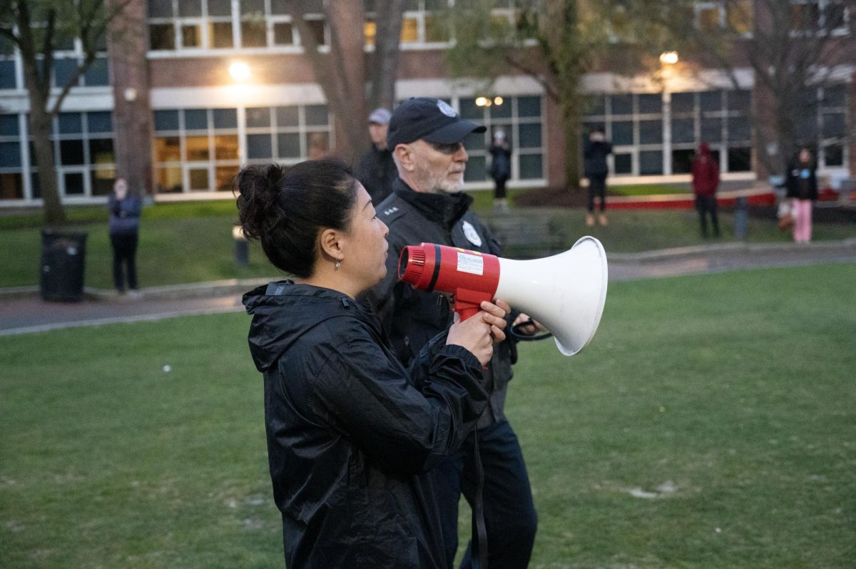 Dean of Students Chong Kim-Wong speaks into a megaphone. Kim-Wong made the first announcement to protesters at 5:33 a.m.