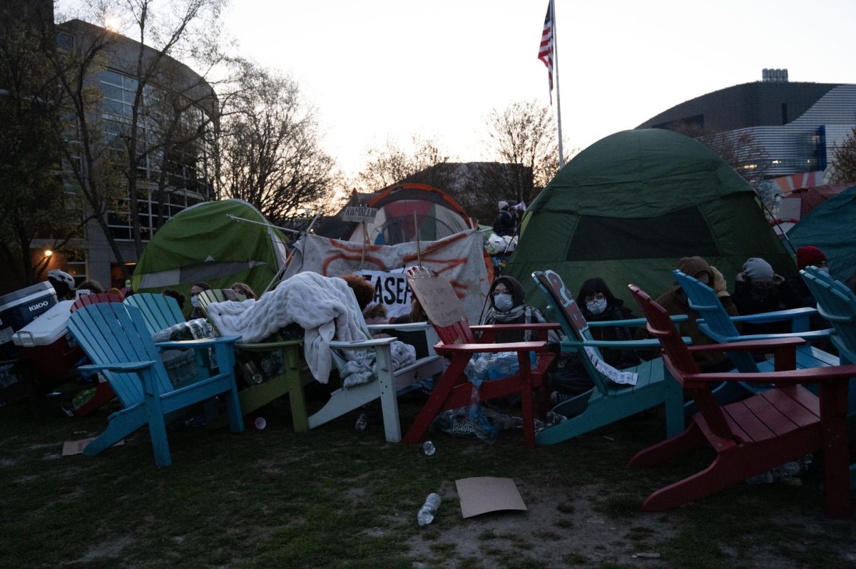 Protesters huddle inside their barricade of chairs. Officers start packing the chairs into Olympia moving trucks at 6:10 a.m.