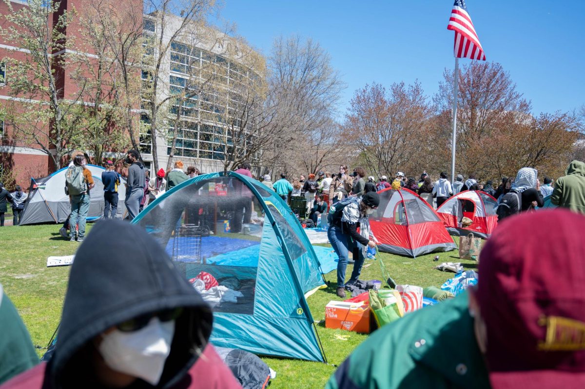 Protesters set up tents and organize supplies in the encampment. They began setting up additional tents around 12:17 p.m. 