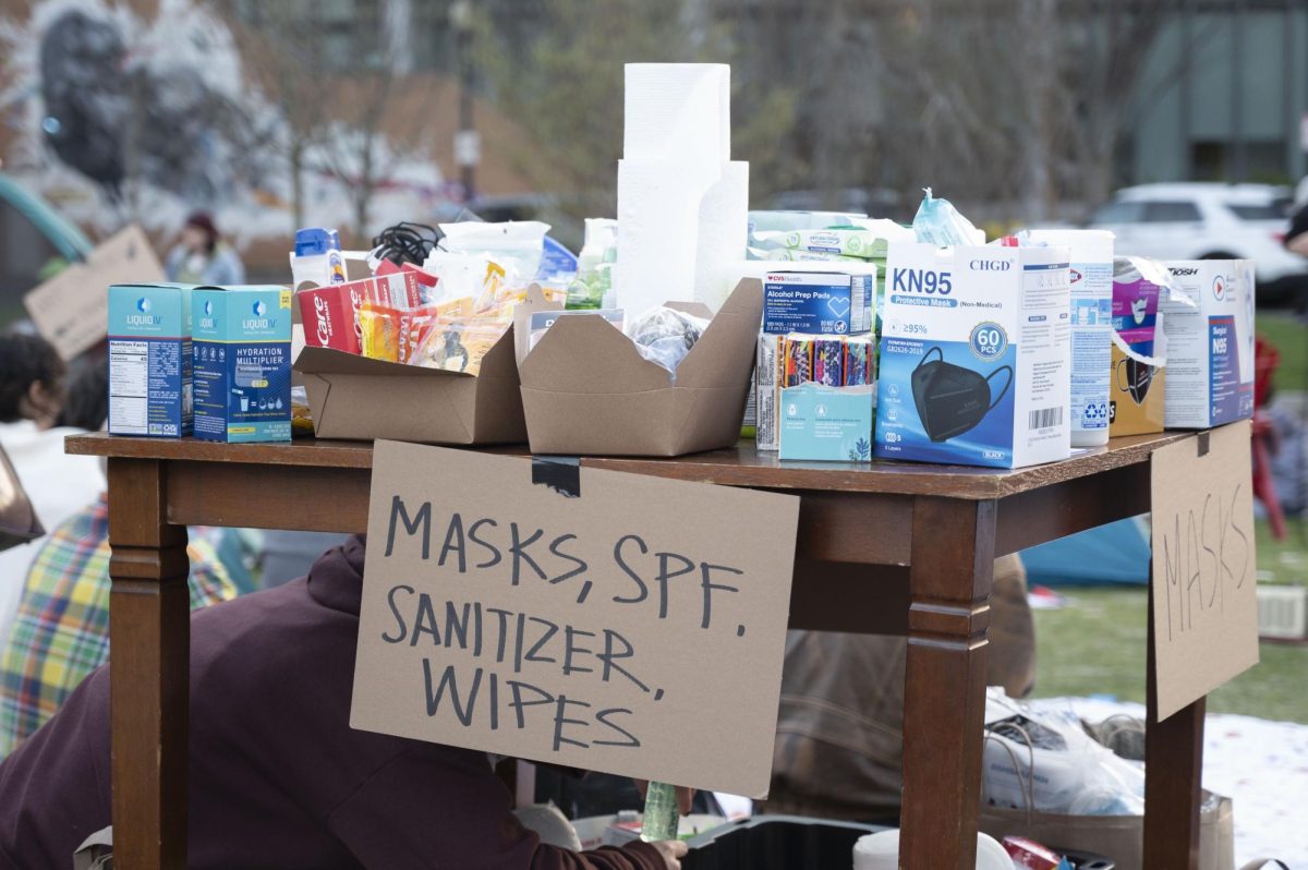 A table holds additional resources including masks, sunscreen, hand sanitizer and wet wipes. These resources were provided throughout the day along with food and drinks.