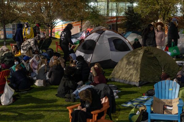 Pro-Palestine demonstrators sit, talk and bundle up on the Common. Demonstrators brought blankets and additional tents in preparation for the cold night. 