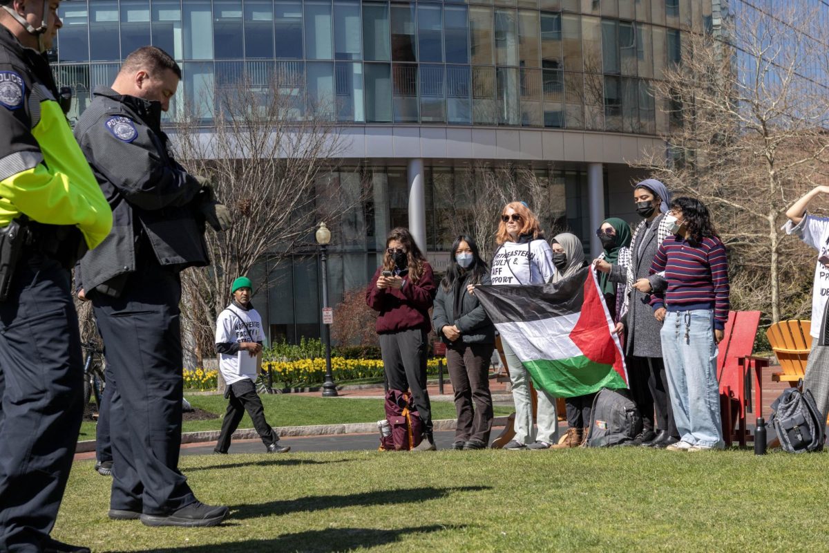 +A+member+of+FSJP+stands+and+holds+a+Palestinian+flag+along+with+pro-Palestine+protesters+on+Centennial+Common+during+the+encampment+April+25.+Twenty+Northeastern+faculty+and+staff+established+FSJP+and+stand+in+solidarity+with+Palestine.+