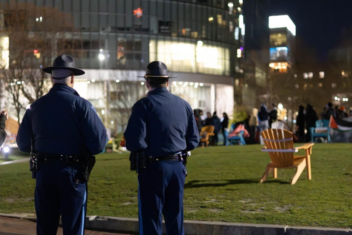 Two state troopers monitor the ongoing pro-Palestine demonstration and prepare for a night watch. 