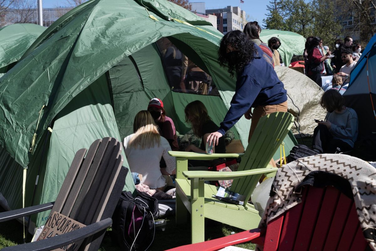 Protesters huddle in a tent around 3:30 p.m. Friday.