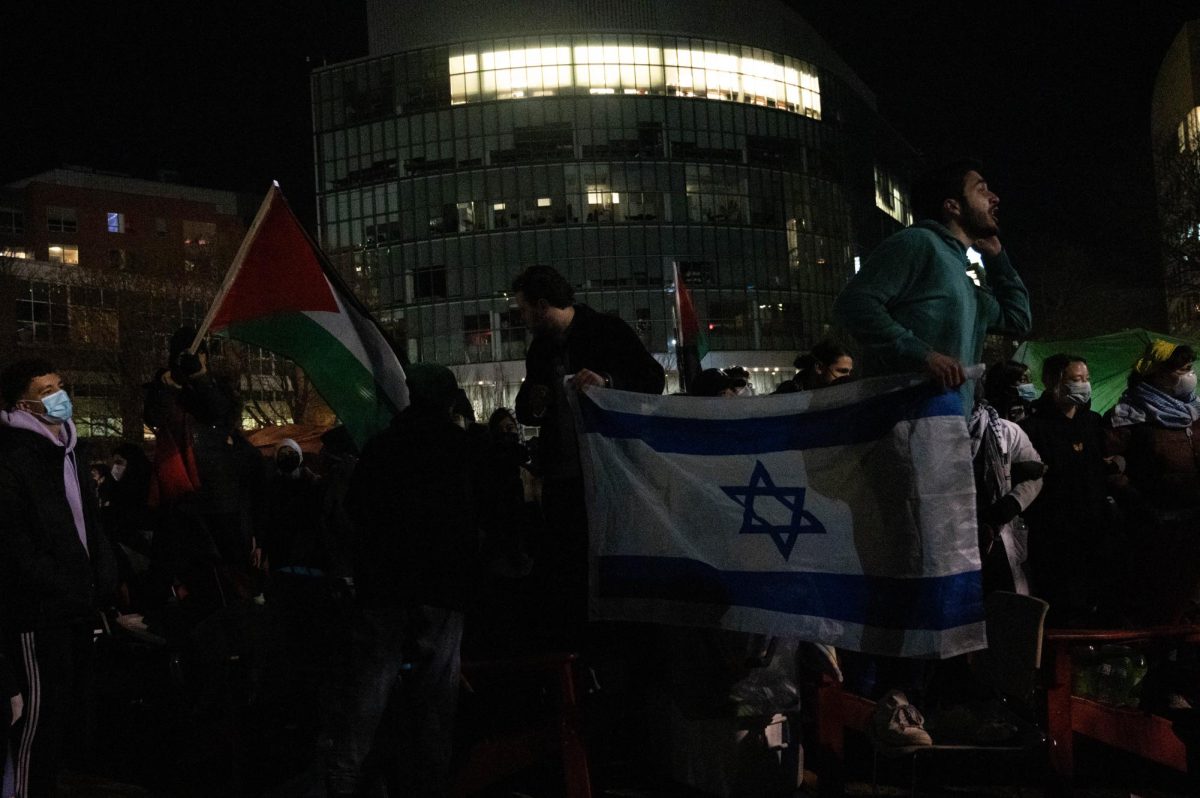 Two pro-Israel counter protesters hold up an Israeli flag in front of the Centennial Common encampment April 26. Video footage revealed one of these counter protesters said the phrase Kill the Jews in an attempt to provoke pro-Palestine demonstrators.