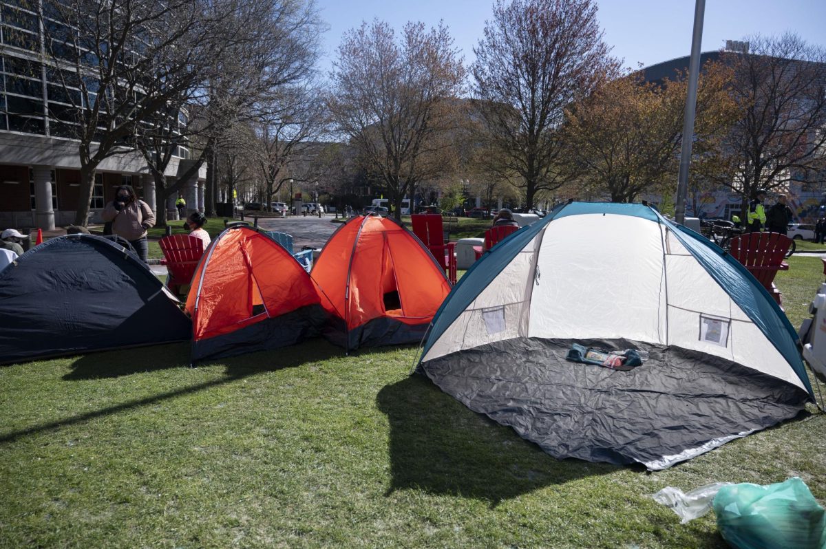 Four tents sit on the outside of the encampment on Centennial Common.