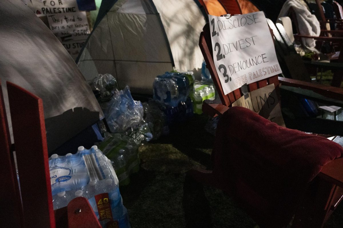 Water bottles, signs, tents and chairs lie in preparation for a possible raid at 11 p.m.