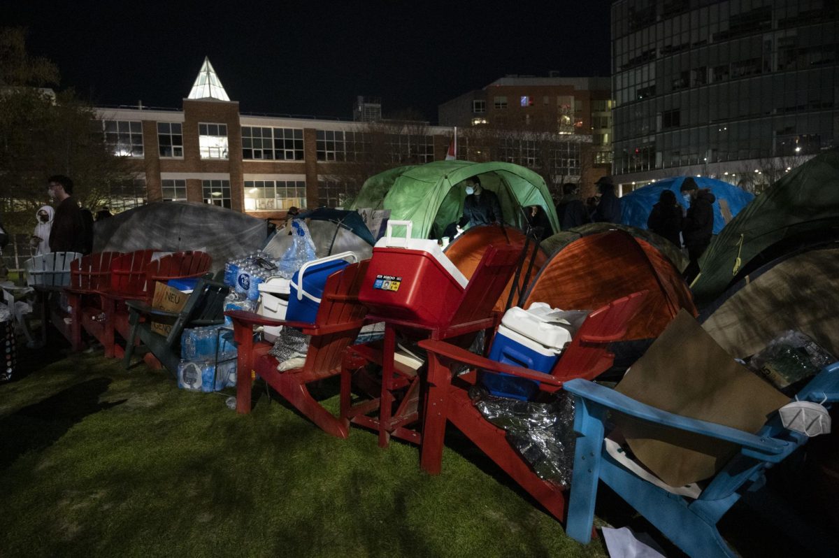 A barricade of chairs and supplies encircles the Commons encampment. 