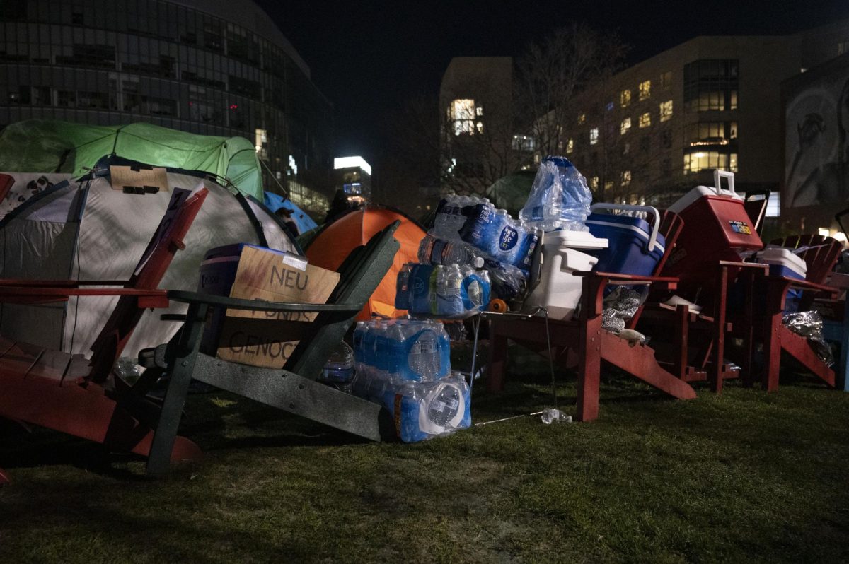 Pro-Palestine demonstrators create a barricade around the Common encampment. They used chairs, waters bottles and coolers. 
