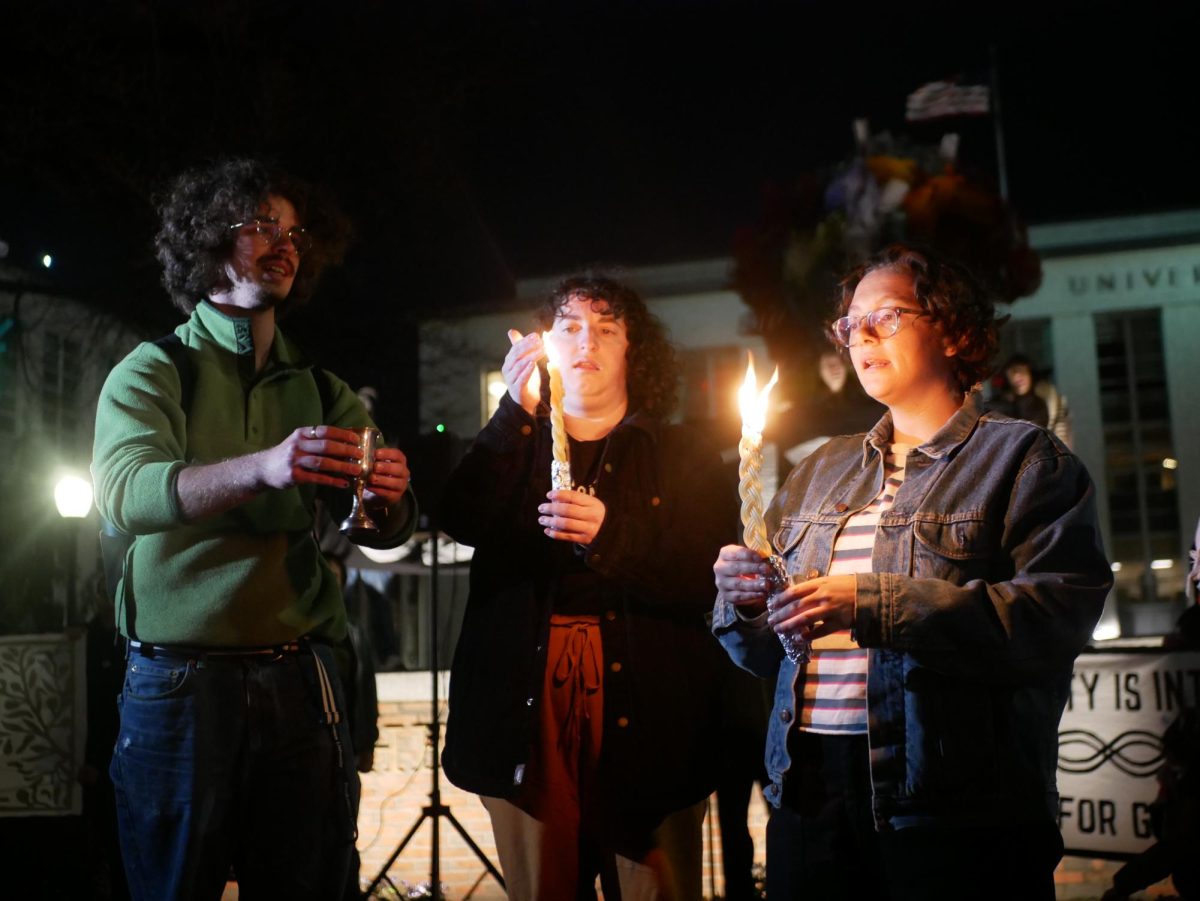 Havdalah attendees hold lit candles while standing in front of Krentzman Quad. Many Northeastern students attended the event.