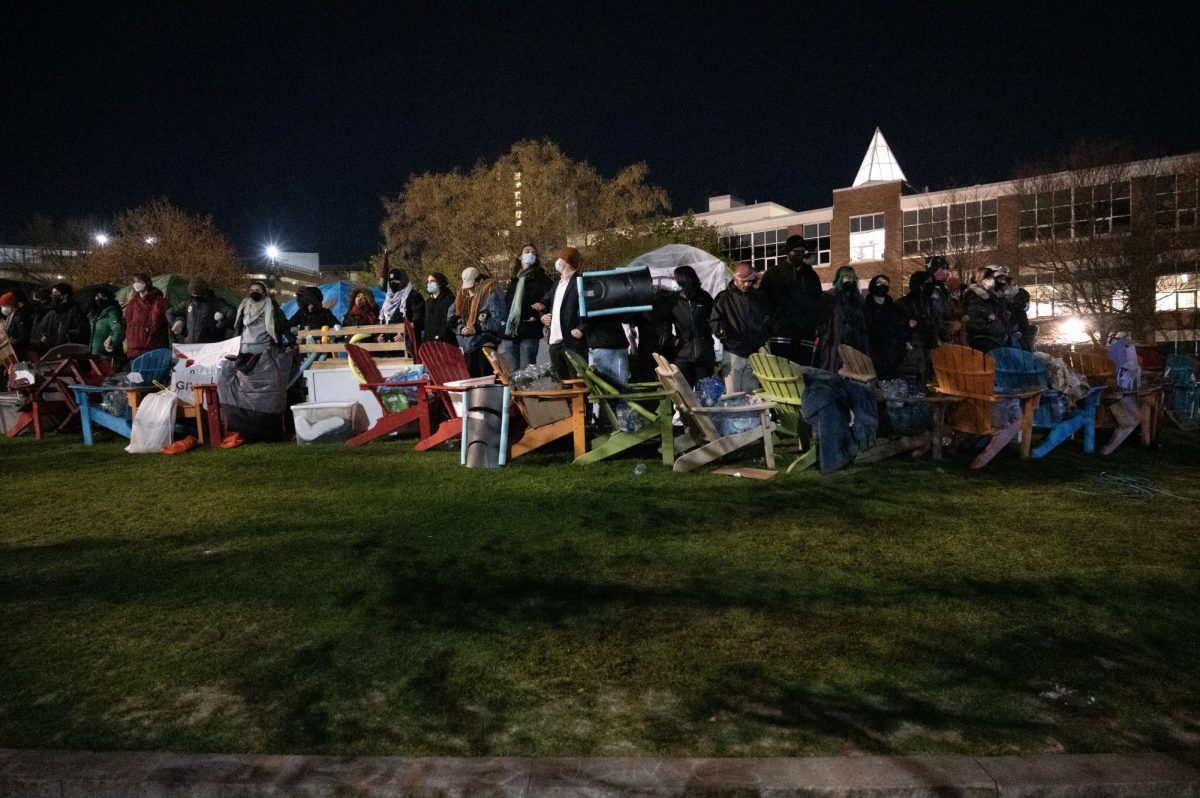 Protesters link arms and chant at 4:30 a.m. They remained continually updated on police movement throughout the morning.