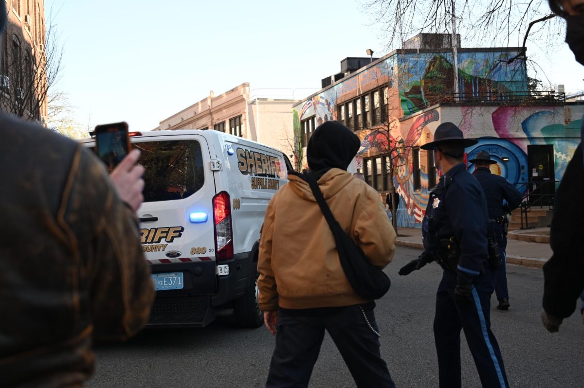 A sheriff van drives away down Forsyth Street. Protesters booed and ran after the van.