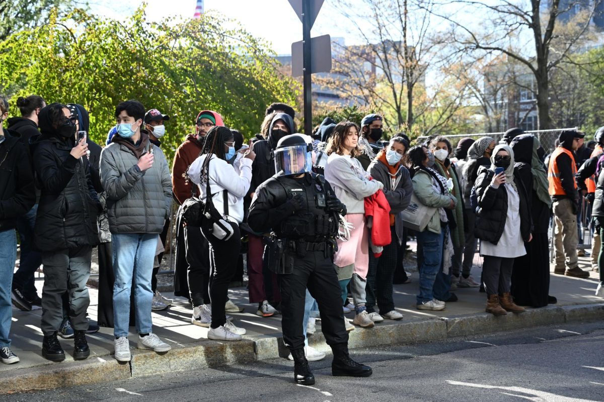 Protesters wait on the sidewalk next to Leon Street. Approximately 100 students remained and shouted out chants. Editors Note: Ali Caudle, center right, was the former deputy city editor for The News.