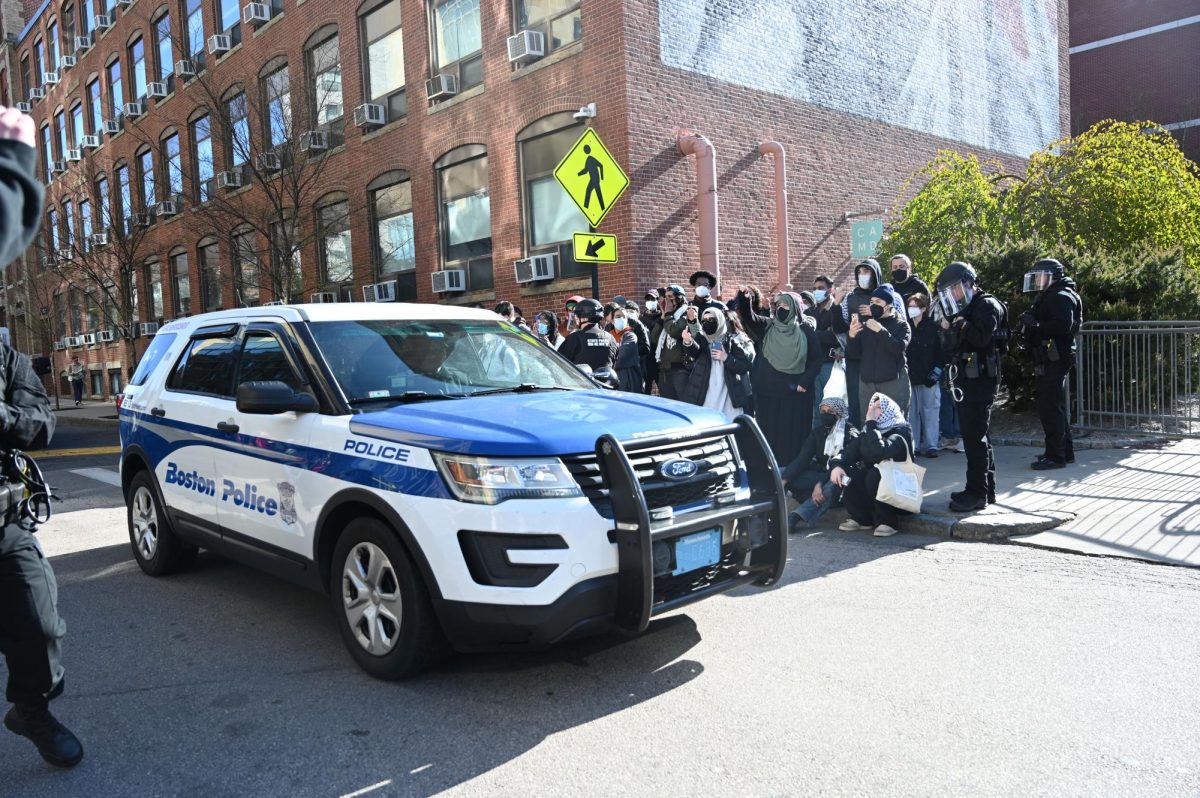 A BPD car is positioned on Leon Street. Cars and vans were used to block demonstrators access to the street.
