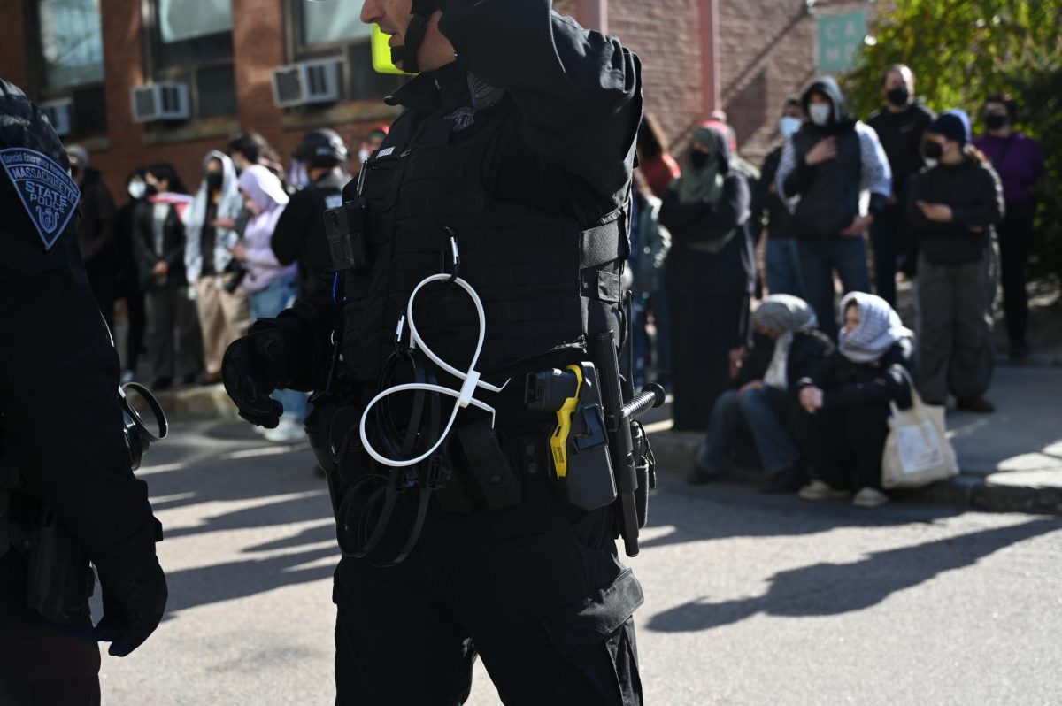 A police officer is seen carrying zip ties attached to their uniform. Protesters were instructed to avoid coming into the street with the officers.