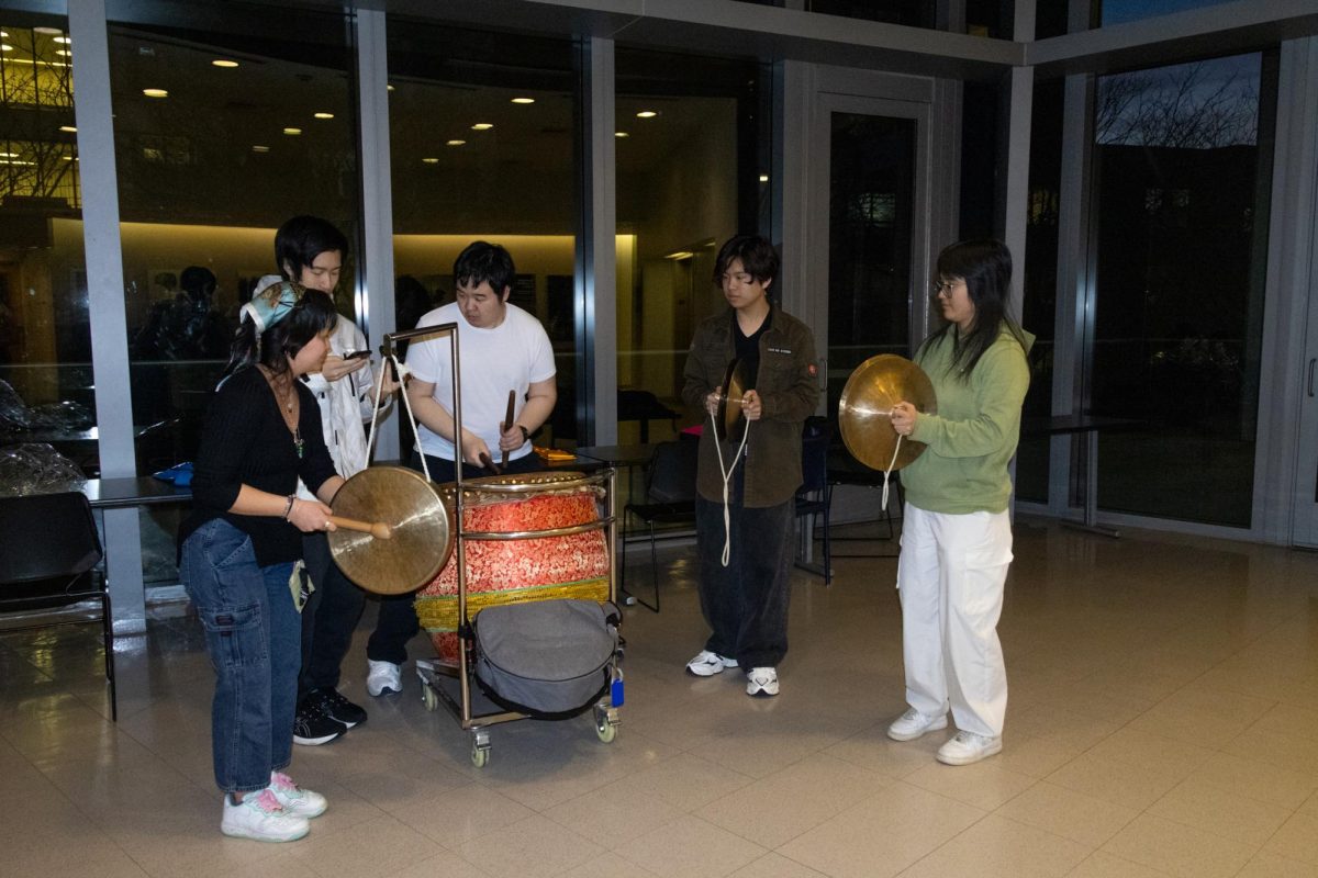 The Dragon & Lion Dance Troupe’s band members practice the music accompaniment to one of the group’s dances with drums, cymbals and gongs. The music was loud, with many cymbal crashes and exciting drum beats to scare off evil spirits.