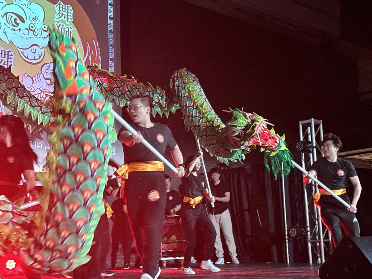 Jonathan Yu (left), a third-year computer science major, carries a pole that holds the dragon’s body while Spencer Shao (right), a fourth-year computer science and music combined major, holds a pole that supports the head of the dragon. This semester, the troupe was able to perform an eye-dotting ceremony, which is traditionally held before a lion or dragon’s first dance to bestow the equipment with the power of providing protection, good luck, health and prosperity.
