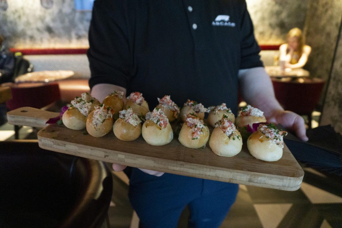 A waiter holds a tray of lobster roll hors d’oeuvres. Waiters quickly and efficiently catered to the hundreds of attendees.