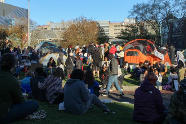 Students sit and watch the encampment. Centennial Common quieted down after BPD left around 3:30. 
