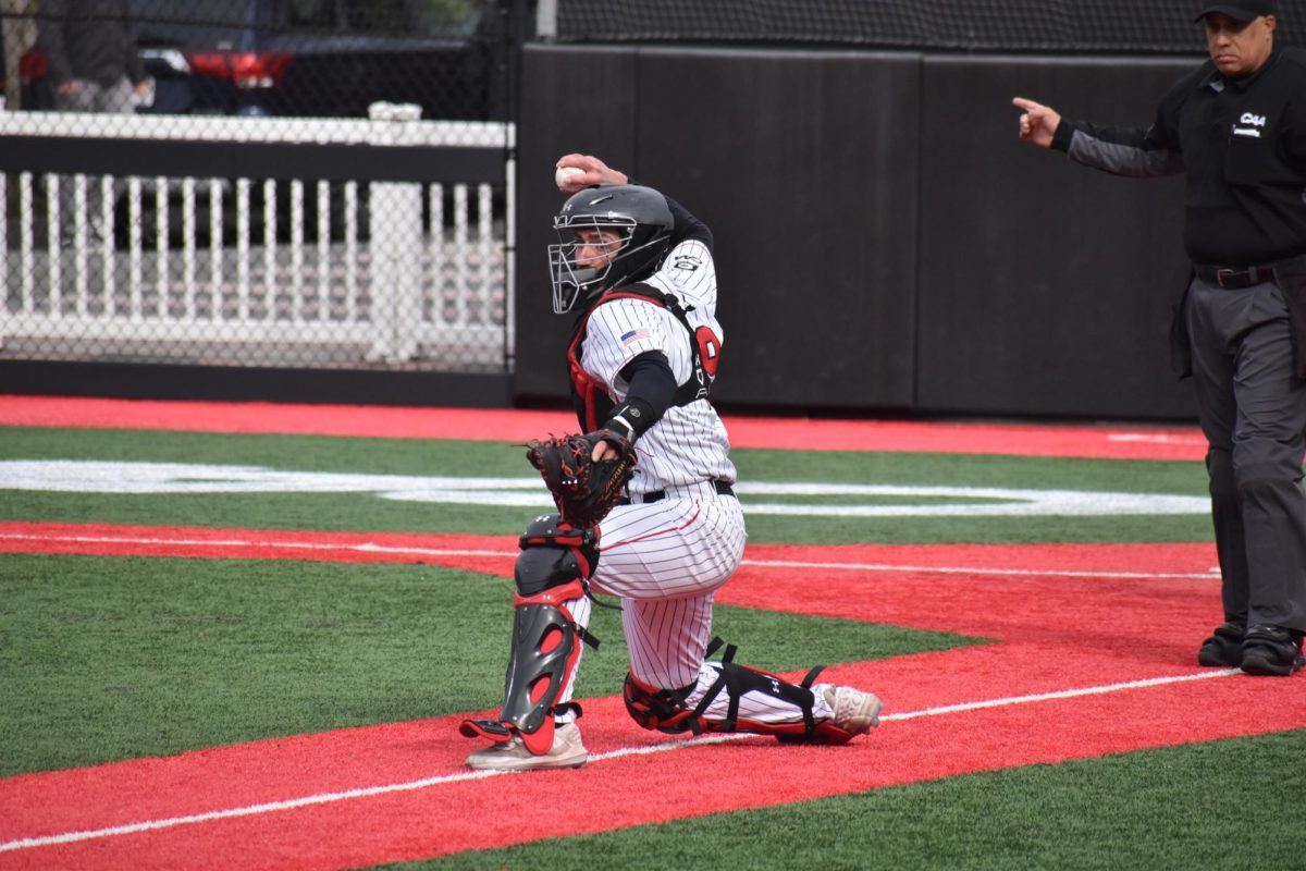 Senior+catcher+Gregory+Bozzo+scans+the+diamond%2C+looking+to+make+a+play.+Bozzo+hit+a+three-RBI+double+in+the+Sunday+afternoon+matchup+against+Towson.
