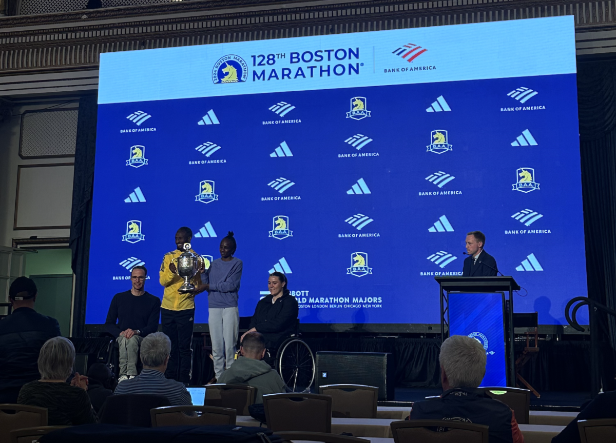 Marcel Hug, the mens wheelchair winner, Sisay Lemma, the mens winner, Hellen Obiri and Eden Rainbow-Cooper, the womens wheelchair winner, hold up a trophy at the champions press conference April 16. Obiri won the womens title by eight seconds, becoming the first woman to win consecutive Boston Marathon titles since Catherine Ndereba in 2004 and 2005.