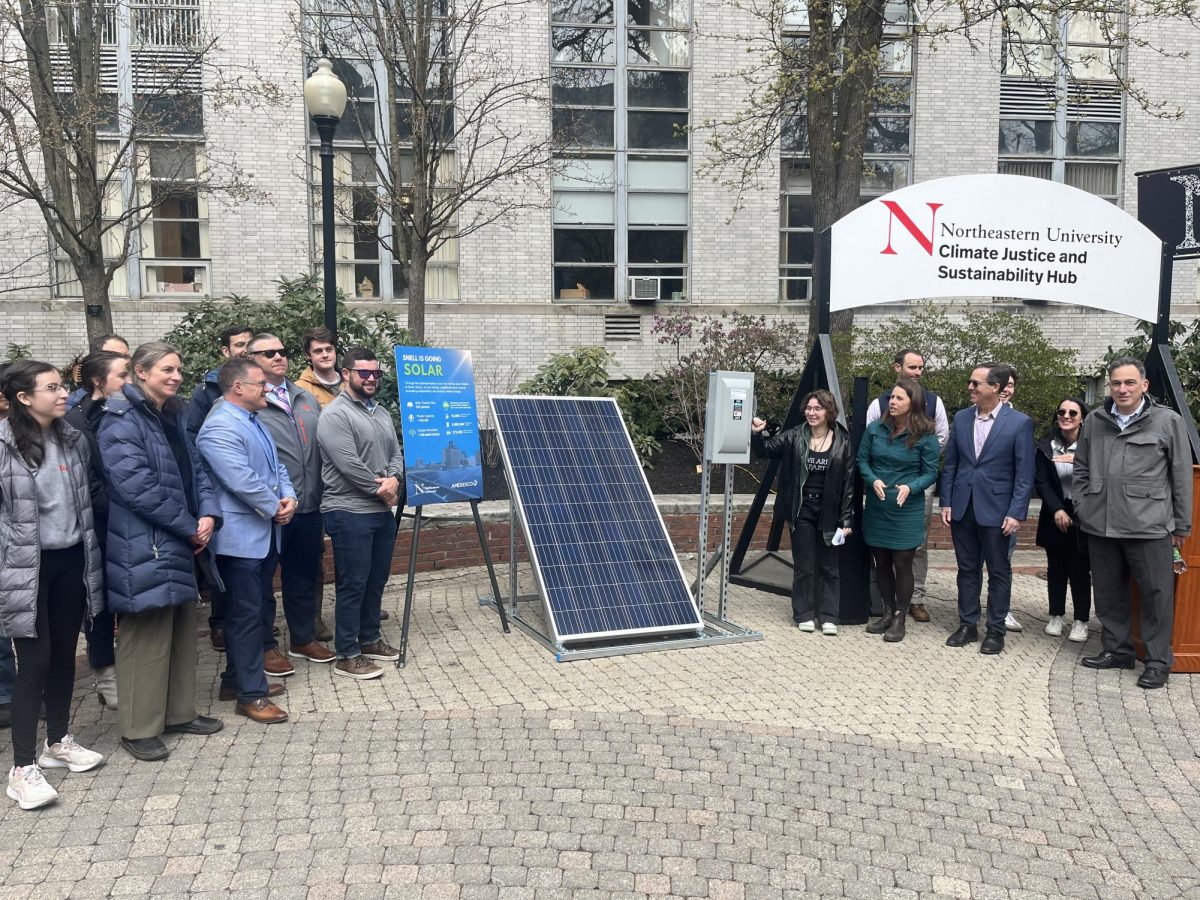 Attendees watch as a solar panel is symbolically turned on. 332 solar panels were activated April 2 as part of the CJS Hubs Snell Solar Celebration. (Editors Note: Mars Poper, center right, is a staff photographer for The News.)