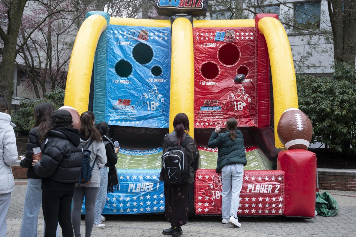 Students line up to take part in an inflatable football game. Other inflatable games included Skee-Ball and basketball.