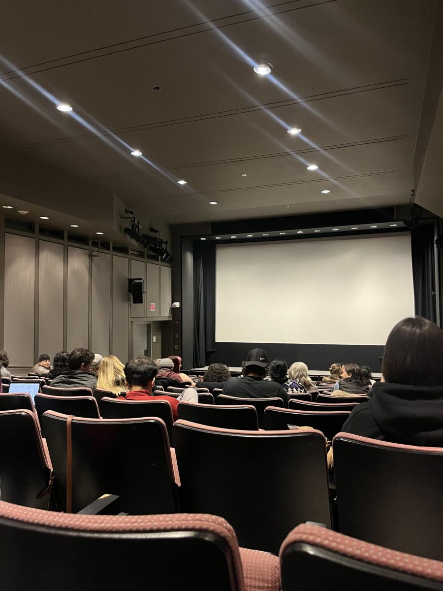Audience members sit in Bartos Theater and wait for a screening of Twice Colonized to begin March 15. The screening was part of the 13th annual Women Take The Reel Film Festival.