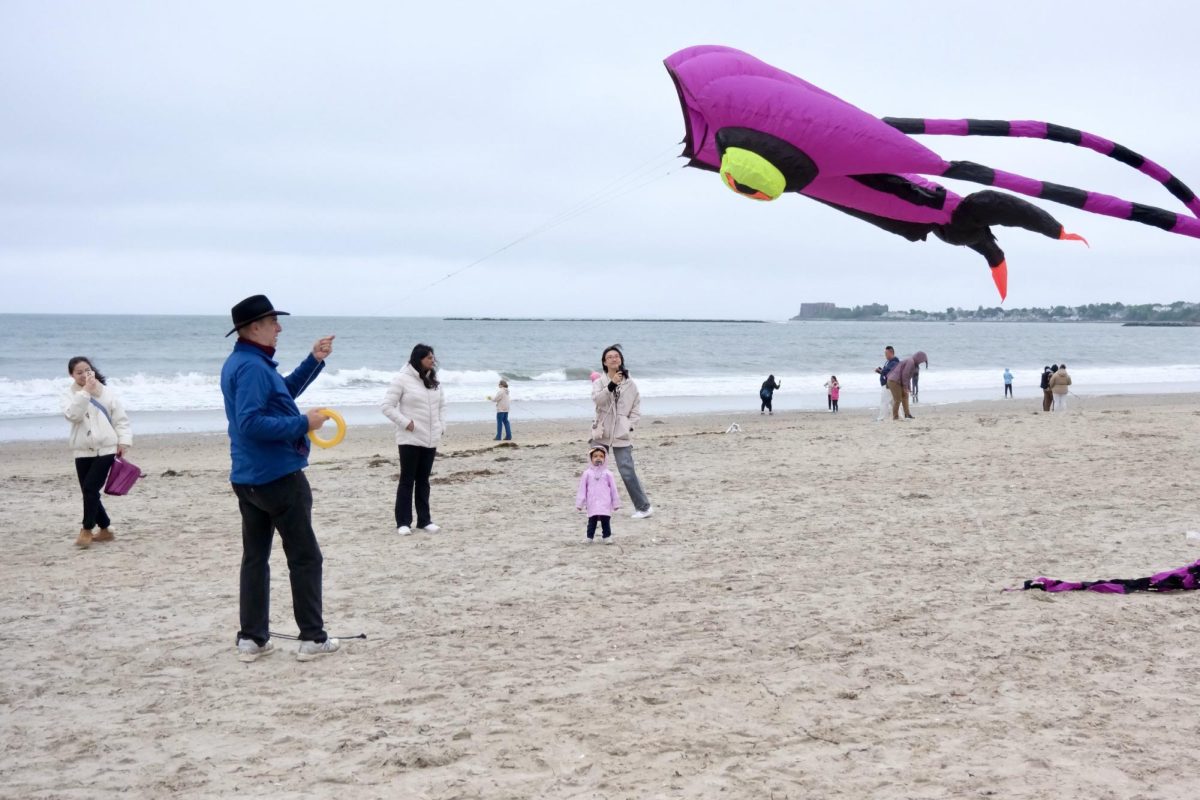A kiteflier lifts a large purple and black octopus kite into the air during the Revere Beach Kite Festival May 19. Read more here.