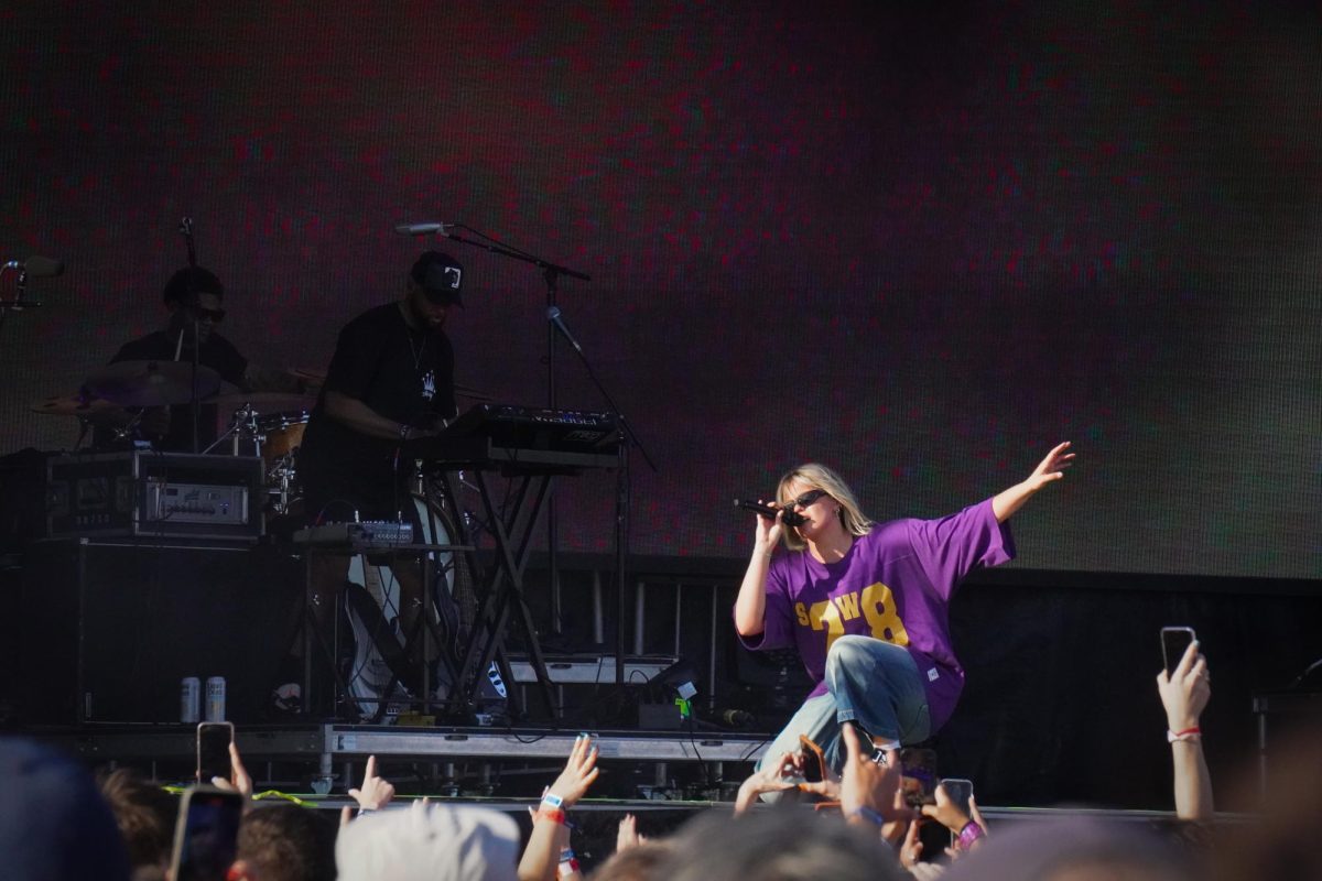 Reneé Rapp outstretches her arm while singing to the audience at Boston Calling May 24. Read more here.