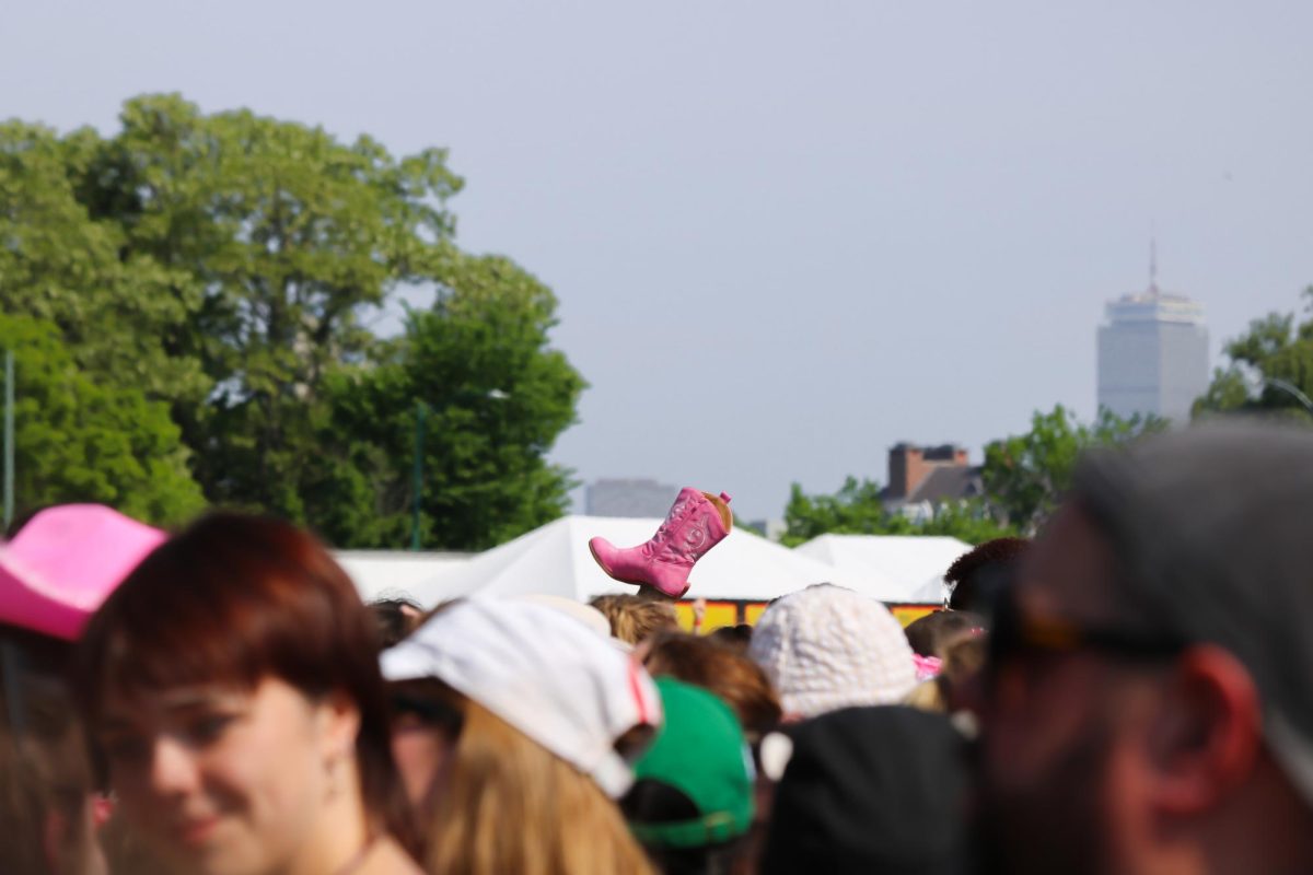 An attendee holds a pink cowboy boot above the crowd a few minutes before Roans performance. Roan’s fans wore pink cowboy hats, boots and feather boas to celebrate the singer’s self-proclaimed identity as the “Midwest Princess.”