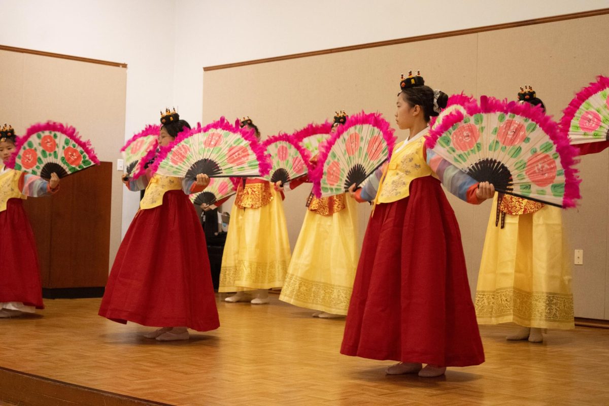 Students+from+the+Baker+School+perform+a+traditional+Korean+fan+dance+known+as+Buchaechum.+The+dancers+wore+brightly+colored+hanboks.