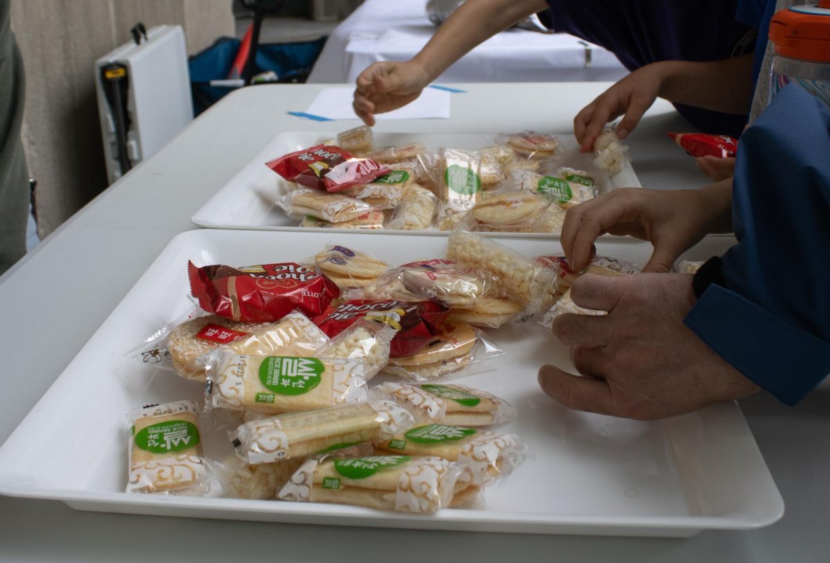 Attendees try Japanese snacks. Snacks such as rice crackers and choco pies were offered.