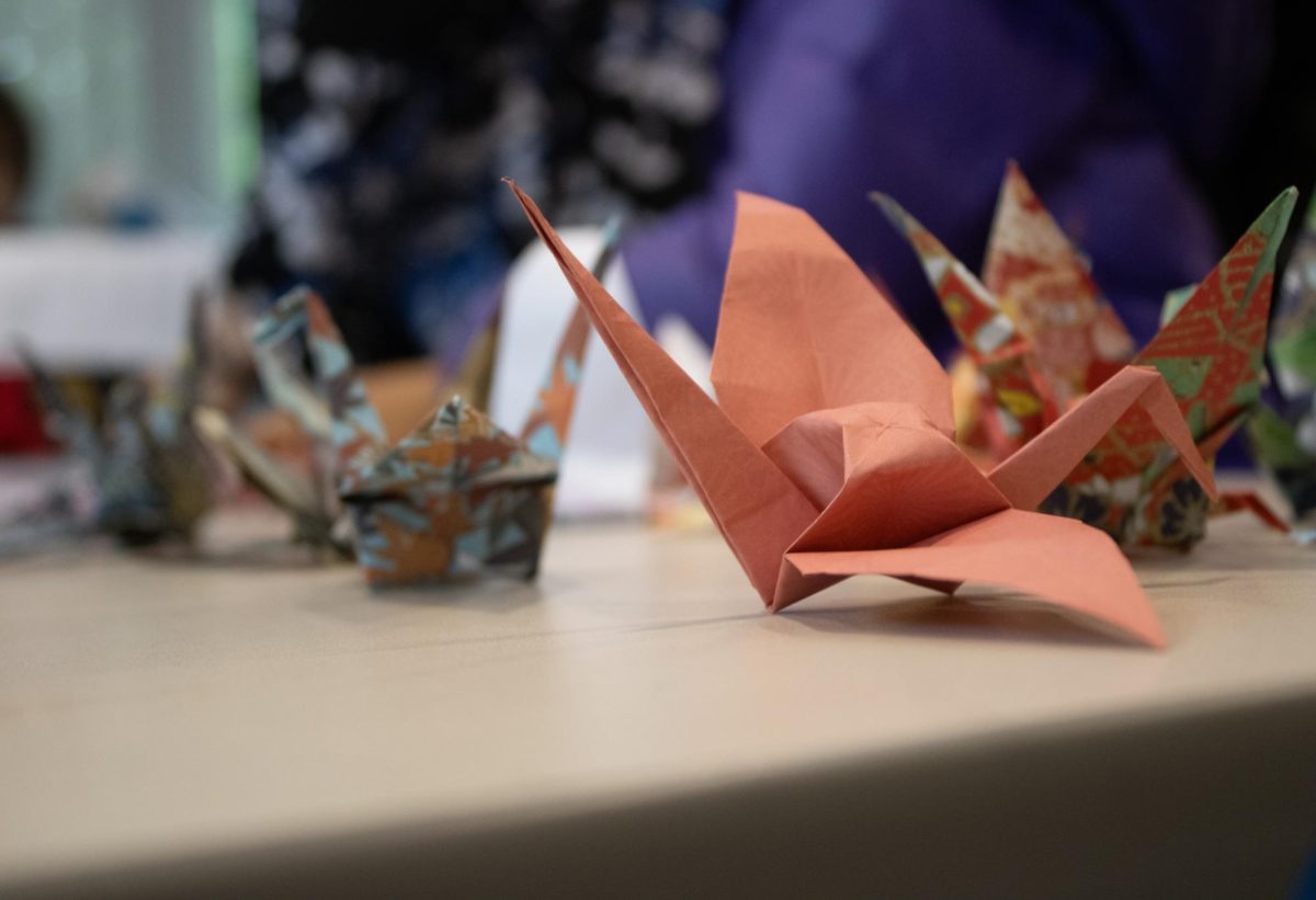 Paper cranes sit on one crafting station. Participants at the origami station learned that in Japanese culture, paper cranes represent good fortune and honor.