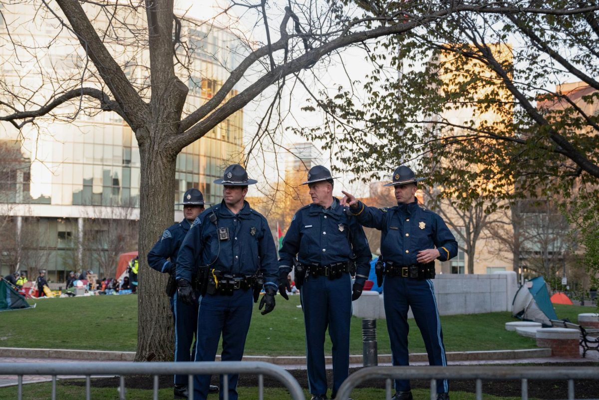 Four Massachusetts State Police officers stand in front of Centennial behind the barricade. Protesters continued to chant phrases such as “We keep us safe” as police removed pieces of their encampment.