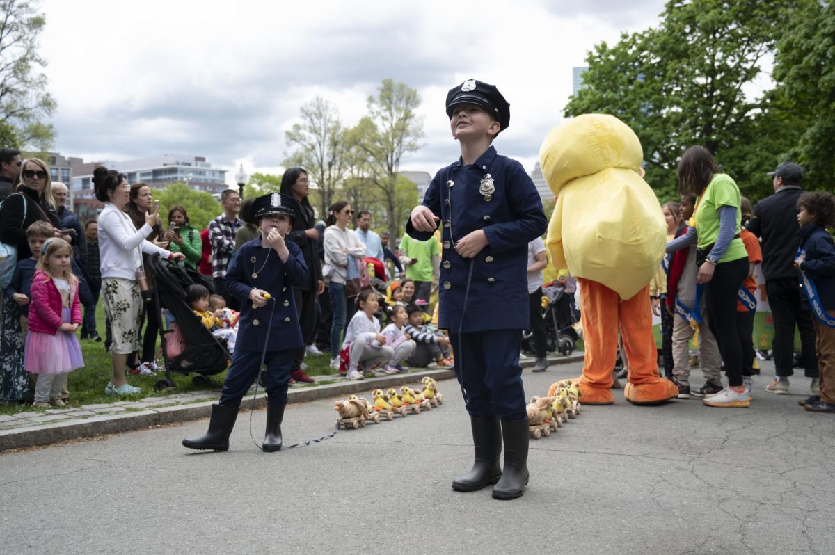 Two children dressed as marshals prepare to lead the parade. They dragged wooden trains of stuffed duck plushies and blew their whistles throughout the parade.