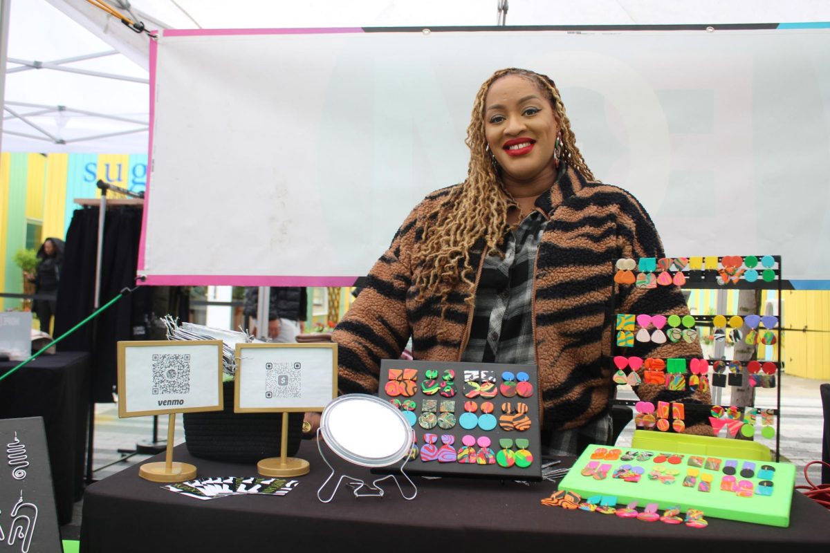 Dominique Dixon poses for a photo with her handmade polymer clay earrings. Dixon founded Mahogani Shop in 2017 using her design background and inspiration from African culture. “I started [Mahogani] in a place where I was trying to rediscover myself as an artist, as a Black woman, Dixon said. So a lot of my influence comes from my culture, architecture, art.”