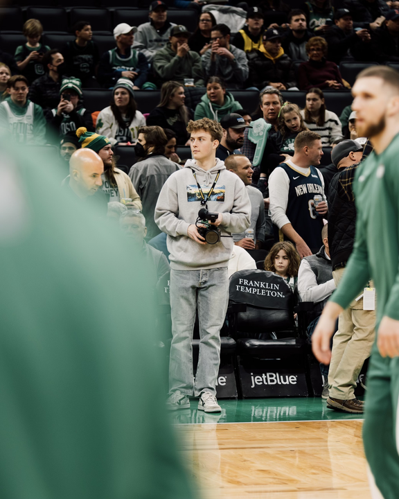 Gage Duchon stands on the sidelines of a Boston Celtics game. He started working for the Celtics over a year ago. Photo courtesy Drew Cigna.