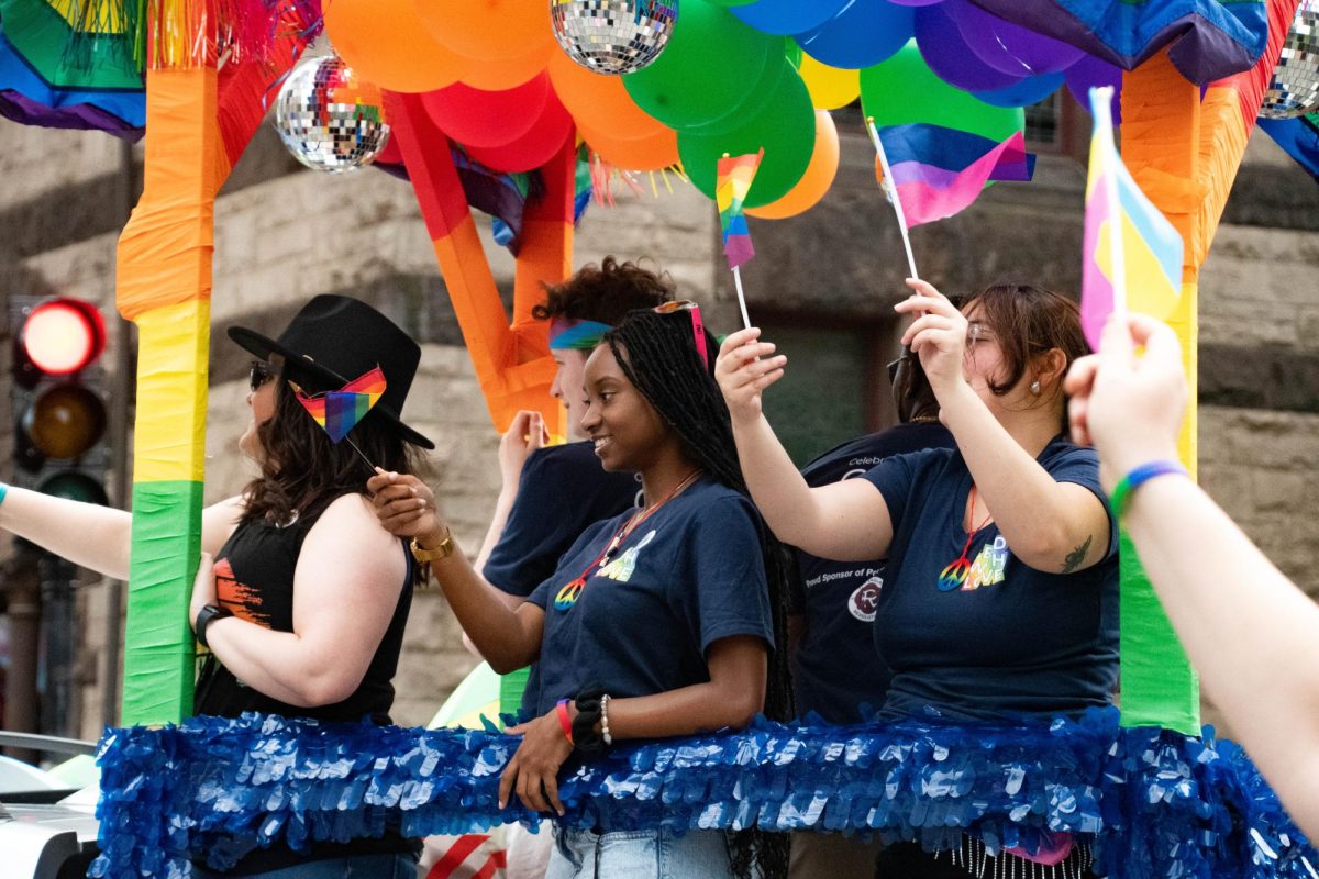 People wave pride flags from the New England Revolution float. The parade drew a crowd of more than 1 million people Saturday.
