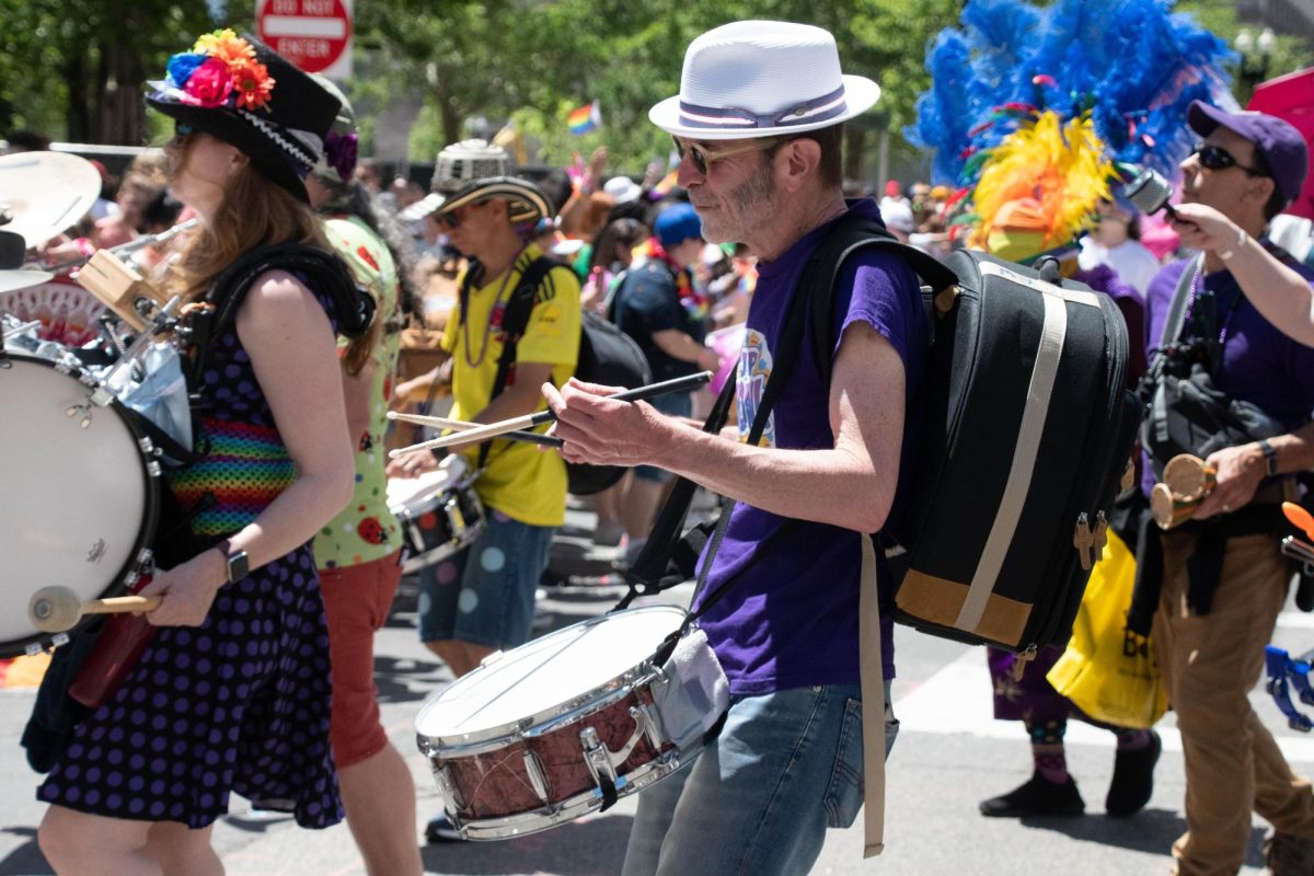 A member of the Jamaica Plain Honk Band plays the drums.