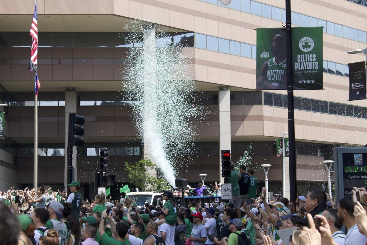 Massive clouds of confetti explode from cannons rolling down Causeway Street. Many spectators climbed boxes, fences, facades and each other to get a better view of the champions.